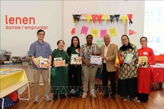 Representatives of the General Association of Vietnamese in Belgium (UGVB) present Vietnamese-language books to the Muntpunt Library. (Photo: VNA)
