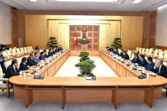 Deputy Prime Minister Ho Duc Phoc, head of the Steering Committee for Enterprise Renewal and Development, holds a working session in Hanoi on August 13 with a visiting delegation from the Lao People’s Revolutionary Party (LPRP) Central Committee’s Commission for State-owned Enterprise (SOE) Reform. (Photo: VNA)
