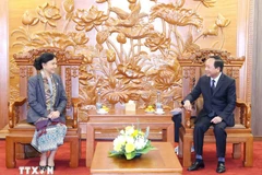 Chairman of the Communist Party of Vietnam (CPV) Central Committee's Commission for Information, Education, and Mass Mobilisation Trinh Van Quyet (right) meets with Standing Vice President of the Lao Front for National Construction Central Committee Inlavan Keobounphanh in Hanoi on December 5. (Photo: VNA)