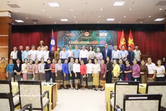 Vietnamese Ambassador to Laos Nguyen Minh Tam and other participants pose for a commemorative photo after a screening of 'Mua Do" (Red Rain) in Vientiane on July 18, 2026. (Photo: VNA)
