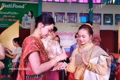 The wrist-tying ritual during Bunpimay is believed to bring peace and good fortune (Photo published by VNA)