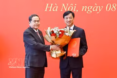 National Assembly Chairman Tran Thanh Man (L) presents a resolution to Nguyen Duy Ngoc, Politburo member, Secretary of the Party Central Committee and Chairman of the Party Central Committee’s Organisation Commission, who is an NA deputy of Hanoi, to transfer his activities from the Hanoi delegation to that of Can Tho city (Photo: VNA)