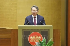 Minister of Justice Nguyen Hai Ninh presents a report on revisions to the draft resolution. (Photo: VNA)