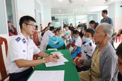 A doctor provides health consultations for the elderly and children in Ly Son island district, Quang Ngai province (Photo: VNA)