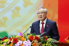 Politburo member, Permanent Vice Secretary of the Government’s Party Committee, and Standing Deputy Prime Minister Nguyen Hoa Binh presents the draft political report. (Photo: VNA)