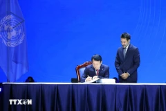 Vietnamese Minister of Public Security Luong Tam Quang signs the Hanoi Convention. (Photo: VNA)