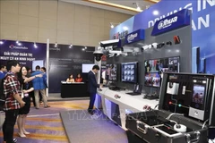 Visitors explore a technology exhibition on cybersecurity and safety equipment. (Photo: VNA)