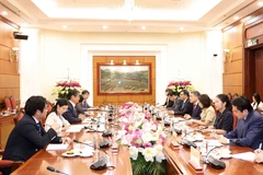 Politburo member, Secretary of the Party Central Committee and Chairman of its Organisation Commission Le Minh Hung (fourth, right) and Japanese Ambassador to Vietnam Ito Naoki (third, left). (Photo: VNA)