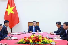 Prime Minister Pham Minh Chinh (centre) in the phone talks with Secretary-General of the People’s Action Party (PAP) and Prime Minister of Singapore Lawrence Wong on May 8. (Photo: VNA)