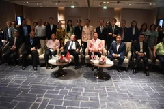 Delegates pose for a group photo at the event (Photo: VNA)