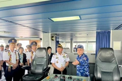 A Vietnam Coast Guard officer (first, right) introduces vessel CBS 8001 to delegates. (Photo: VNA)