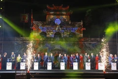 Delegates press the buttons to kick off the event (Photo: VNA)