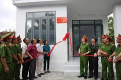 Khanh Hoa police hand over a new house to a local family. (Photo: VNA)