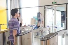 Passengers check in for flights using the VneID application at Noi Bai International Airport. (Photo: VietnamPlus)