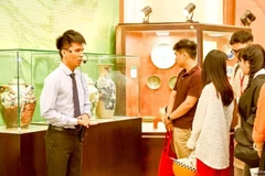 A tour guide at the History Museum of Ho Chi Minh City introduces exhibits to visitors. (Photo: sggp.org.vn)