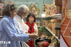 Customers explore products at a Vietnamese enterprise’s booth. (Illustrative photo: VNA)