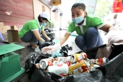 Workers collect waste for recycling in Hanoi (Photo: VNA)