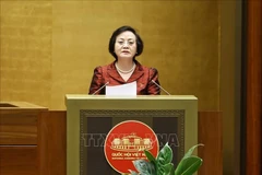Minister of Home Affairs Pham Thi Thanh Tra, authorised by the Prime Minister, presents a report explaining, accepting and revising opinions on the draft Law on Cadres and Civil Servants (amended). (Photo: VNA)