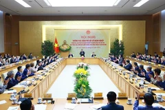 Prime Minister Pham Minh Chinh (C) speaks at the meeting between permanent Government members with leaders of businesses on February 10. (Photo: VNA)