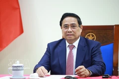 Prime Minister Pham Minh Chinh speaks at the phone talks with Angolan President Joao Manuel Goncalves Lourenco on March 16. (Photo: VNA)