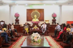 At the working session (Photo: VNA)