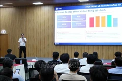 Nguyen Thanh Lam, head of the Quang Trung Software City (QTSC)'s Cybersecurity Centre, speaks at the workshop. (Photo: VNA)