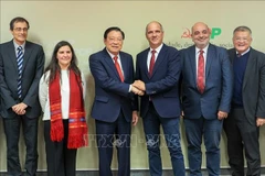 Phan Dinh Trac, Politburo member, Secretary of the Communist Party of Vietnam (CPV) Central Committee and head of its Commission for Internal Affairs, shakes hands with Paulo Raimundo, Secretary-General of the Portuguese Communist Party, during the Vietnamese Party delegation's working trip to Portugal from November 22-27. (Photo: VNA)