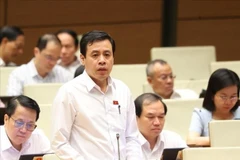 NA deputy Tran Anh Tuan of HCM City says that shifting to a market-based management approach, allowing qualified enterprises to join the production, trading, and distribution of gold as a regular commodity, would help narrow the price gap. (Photo: VNA)