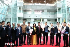 The honoured enterprises and individuals at the event. (Photo: VNA)