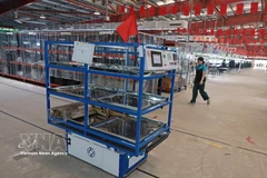 Robots automatically transport materials from the warehouse to the production line at Maxport Limited Vietnam (Photo: VNA)