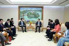 Deputy Prime Minister Le Thanh Long (R) receives Chinese Ambassador to Vietnam He Wei in Hanoi on December 25. (Photo: VNA)