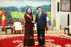 General Secretary of the Lao People’s Revolutionary Party (LPRP) and President of Laos Thongloun Sisoulith (R) receives Vietnamese State Vice President Vo Thi Anh Xuan on August 21. (Photo: VNA)