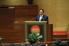 PM Pham Minh Chinh delivers the report at the session. (Photo: VNA)