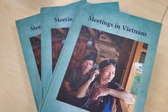 Mrs Binh appears on the cover of the photo book “Meetings in Vietnam.” (Photo: VietnamPlus)