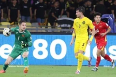 Vietnamese goalkeeper Filip Nguyen (left) makes a crucial save to deny a goal in the match against Malaysia on June 10, 2025. (Photo: VNA)