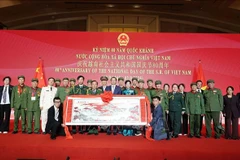 Delegates pose for a photo with a group of Chinese veterans who supported Vietnam during the war at the event (Photo: VNA)