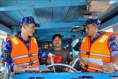 Law enforcement forces at sea in Ho Chi Minh City are working to raise awareness among fishermen about combating illegal, unreported, and unregulated (IUU) fishing (Photo: VNA)