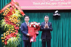 Politburo member, Secretary of the Party Central Committee, and Chairman of its Organisation Commission Le Minh Hung (R) hands overs the decision to Nguyen Dinh Trung at a ceremony on October 17, 2025 (Photo: VNA)