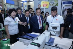 Delegates visit a booth at the exhibition (Photo: VNA)