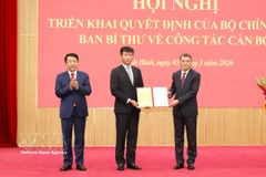 Le Minh Hung, Politburo member, Secreary of the Party Central Committee and Chairman of the committee's Organisation Commission (R) presents the appointment decision to Tran Huy Tuan. (Photo: VNA)