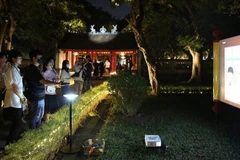 Visitors take part in a night tour at the Temple of Literature (Van Mieu – Quoc Tu Giam) in Hanoi. (Photo: nhandan.vn)