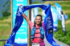 Ngo Van Chinh of the Sa Pa Ethnic Running Club finishes first with an impressive time of 13:00:10, setting a new course record for the race (Photo: VNA)