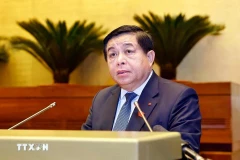 Minister of Planning and Investment Nguyen Chi Dung delivers a report on the revised 2025 socio-economic development plan. (Photo: VNA)