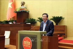 Minister of Transport Tran Hong Minh presents the proposed resolution. (Photo: VNA)