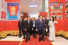 Officials visit the photo exhibition “Under the Party’s Leadership – The nation enters a new era” at the National Convention Centre in Hanoi on January 14. (Photo: VNA)