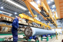 Production activities at a centrifugal concrete pillar manufacturing plant (Photo: VNA)