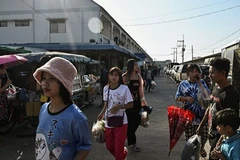 This photo, taken on January 26, 2025, shows Myanmar migrant workers walking to an outdoor market in Thailand's Samut Sakhon province. (Photo: AFP)