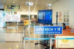 Noi Bai International Airport has rolled out measures to tighten health controls and strictly monitor inbound passengers in an effort to prevent complicated developments of the Nipah virus outbreak. (Photo: nhandan.vn)
