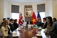 Vietnamese Ambassador to the UK Do Minh Hung (centre) delivers the opening remarks at the the workshop in London on June 9. (Photo: VNA)