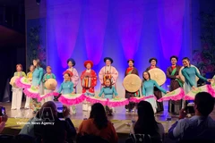 An ao dai fashion show at the grand music programme on March 8, presented by the Vietnamese ao dai heritage club in Belgium in coordination with the UGVB Women’s Association. (Photo: VNA)